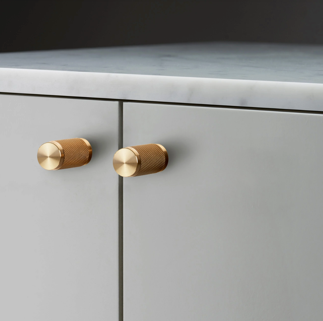 brass drawer handles on grey kitchen unit